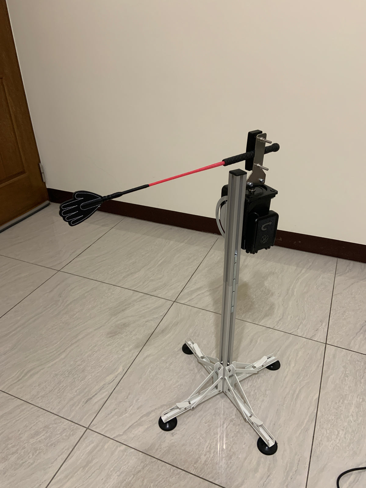 High-torque electric tapping massage machine with adjustable stand for deep tissue muscle relief.